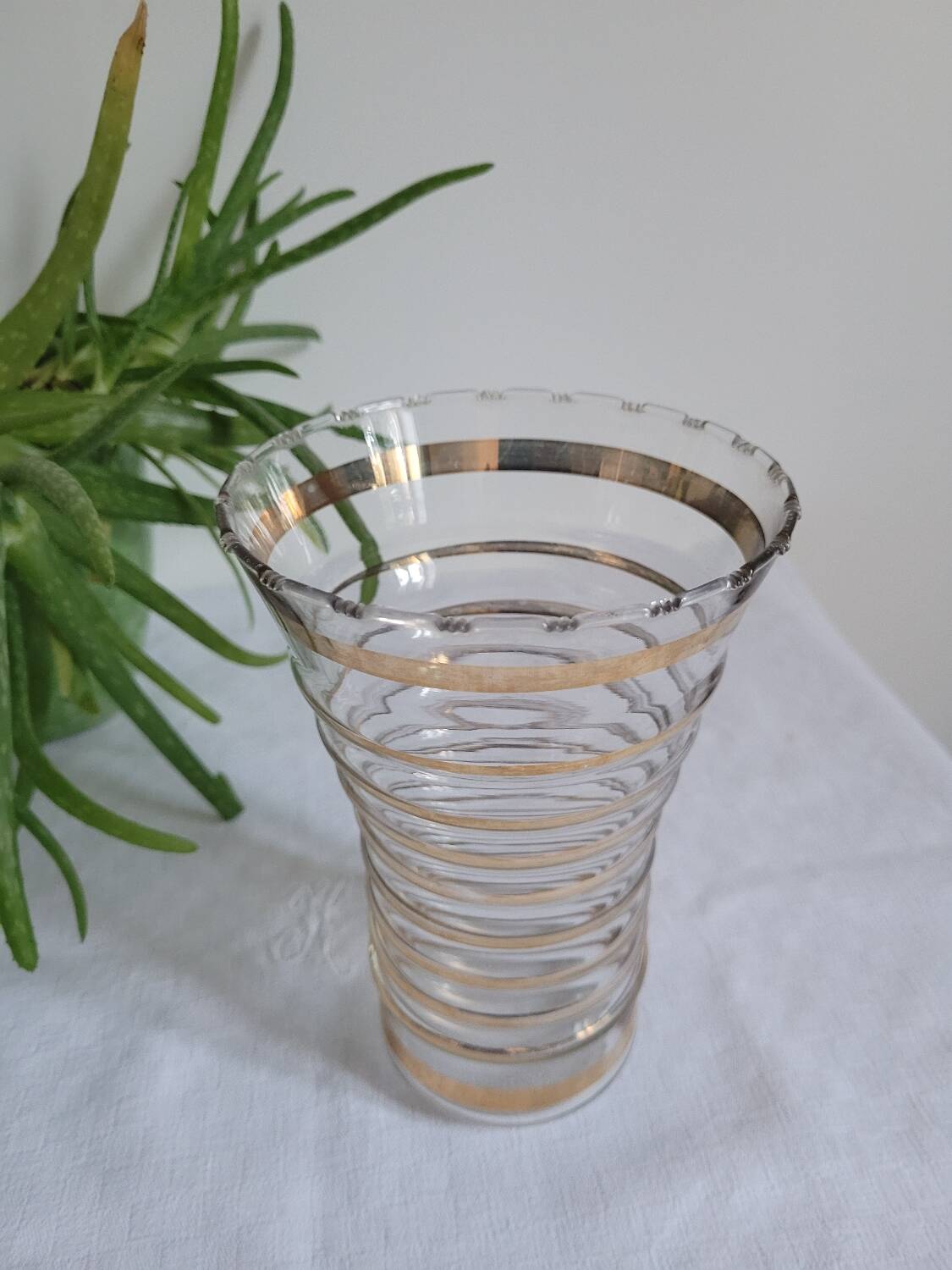 Vase with golden trim and lace-edged rim.