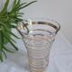 Vase with golden trim and lace-edged rim.