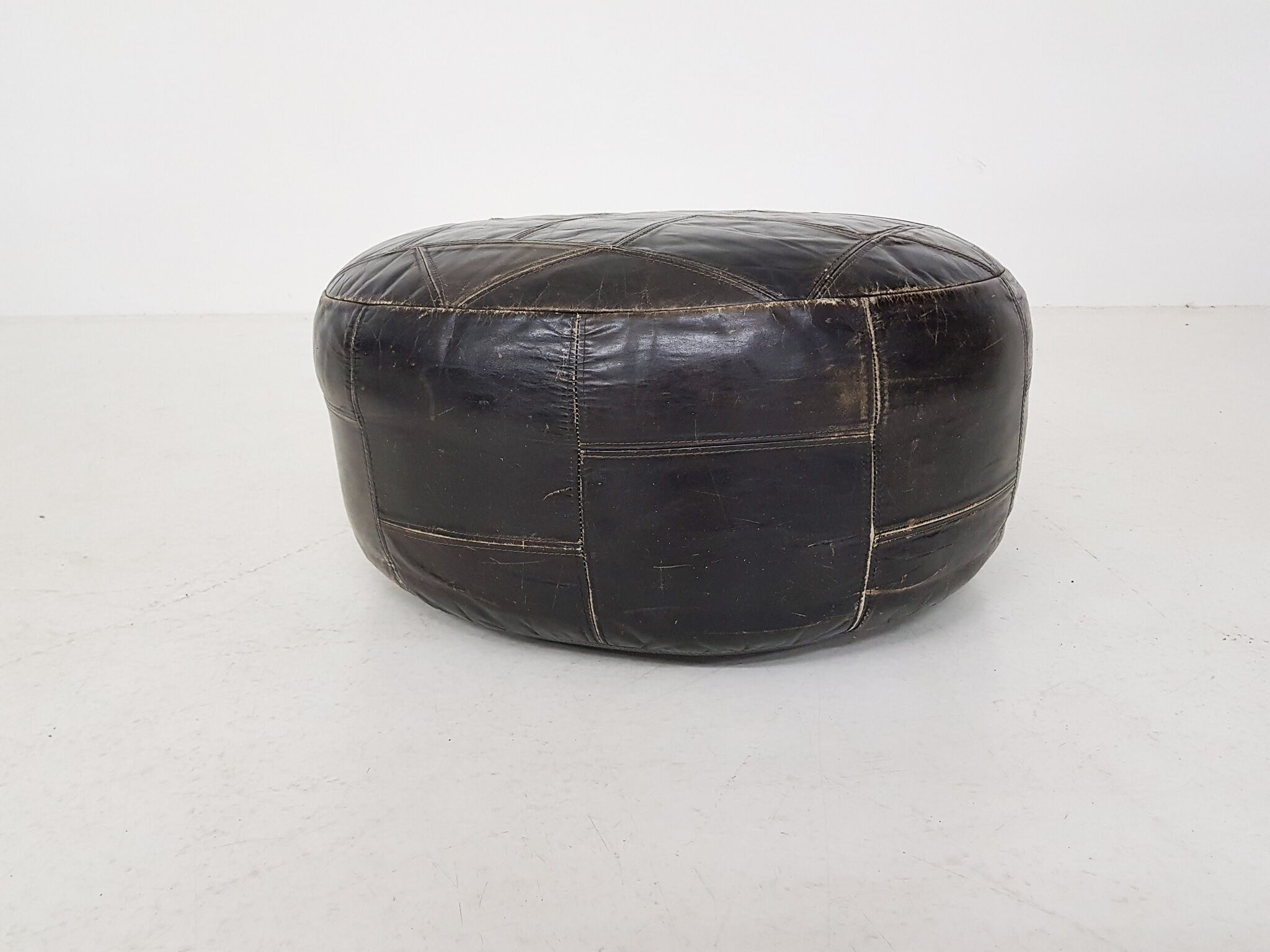 Mid-century round leather ottoman