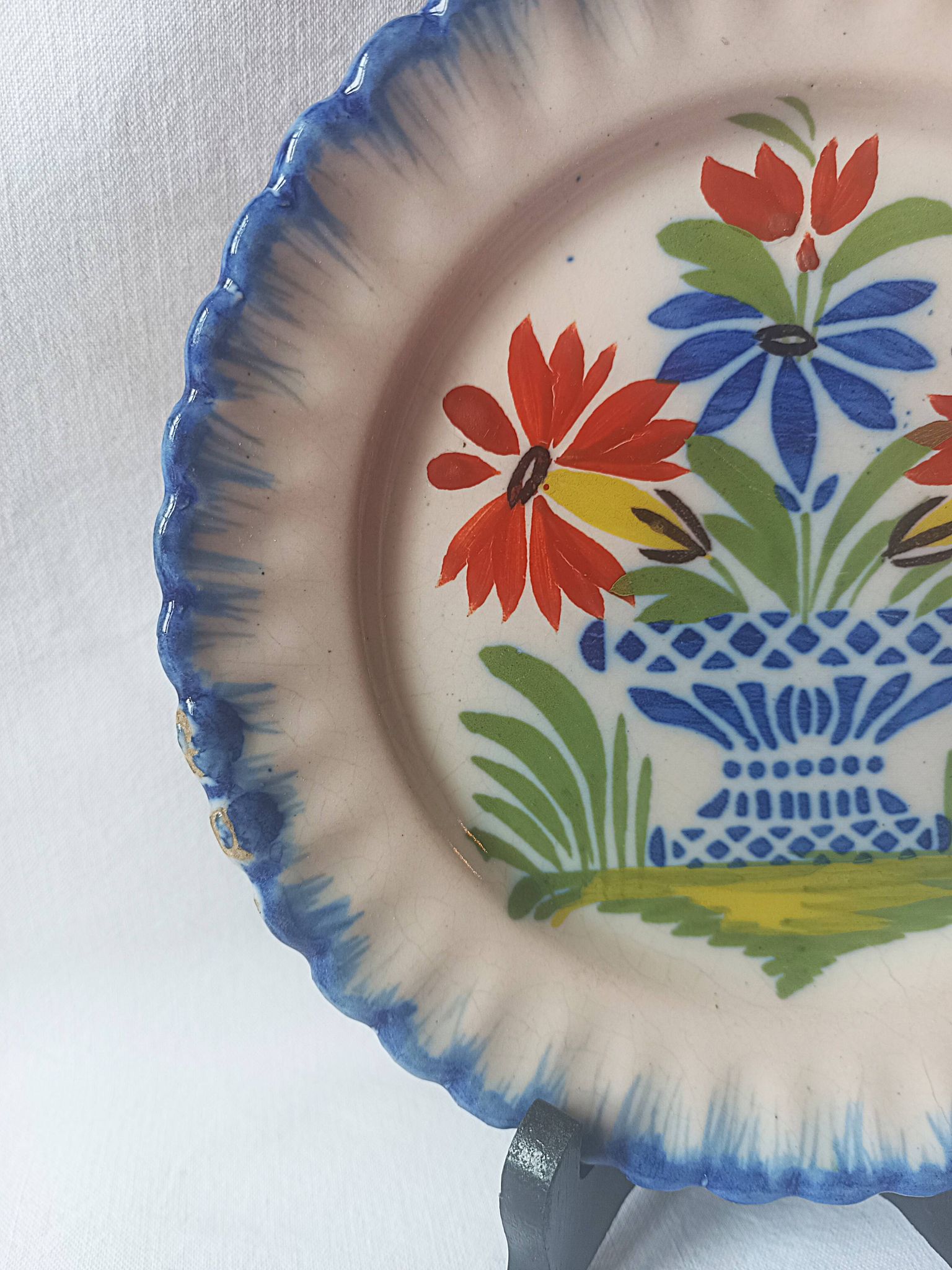 Pair of antique plates in popular earthenware with a floral basket decoration on the edge.