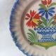 Pair of antique plates in popular earthenware with a floral basket decoration on the edge.