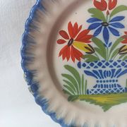 Pair of antique plates in popular earthenware with a floral basket decoration on the edge.