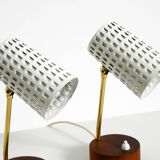 A pair of mid-century modern bedside lamps with perforated metal shades