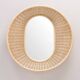Important round and convex mirror in woven rattan.
