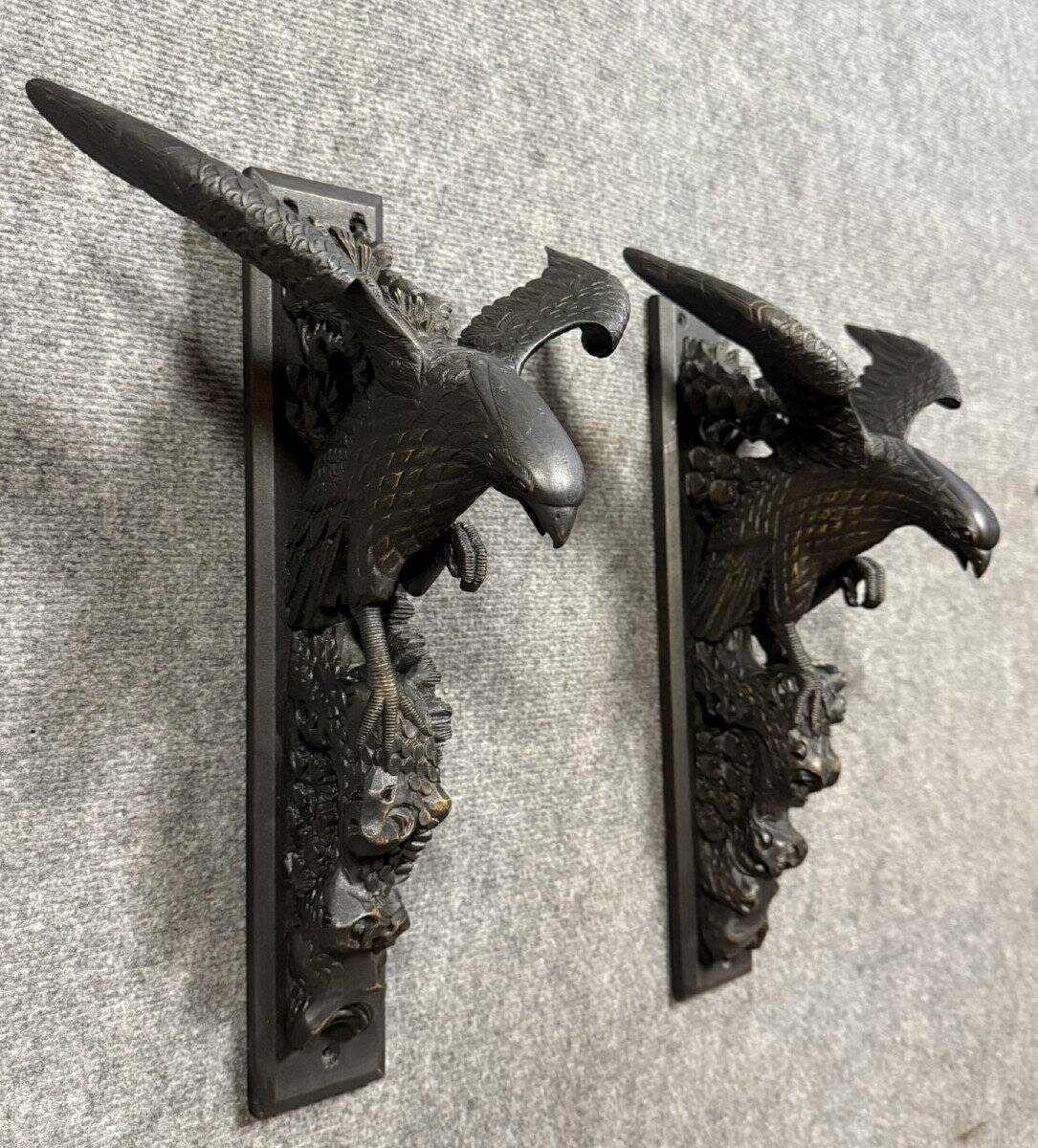 Rare pair of patinated wooden wall consoles, featuring two eagles with outstretched wings.