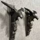 Rare pair of patinated wooden wall consoles, featuring two eagles with outstretched wings.