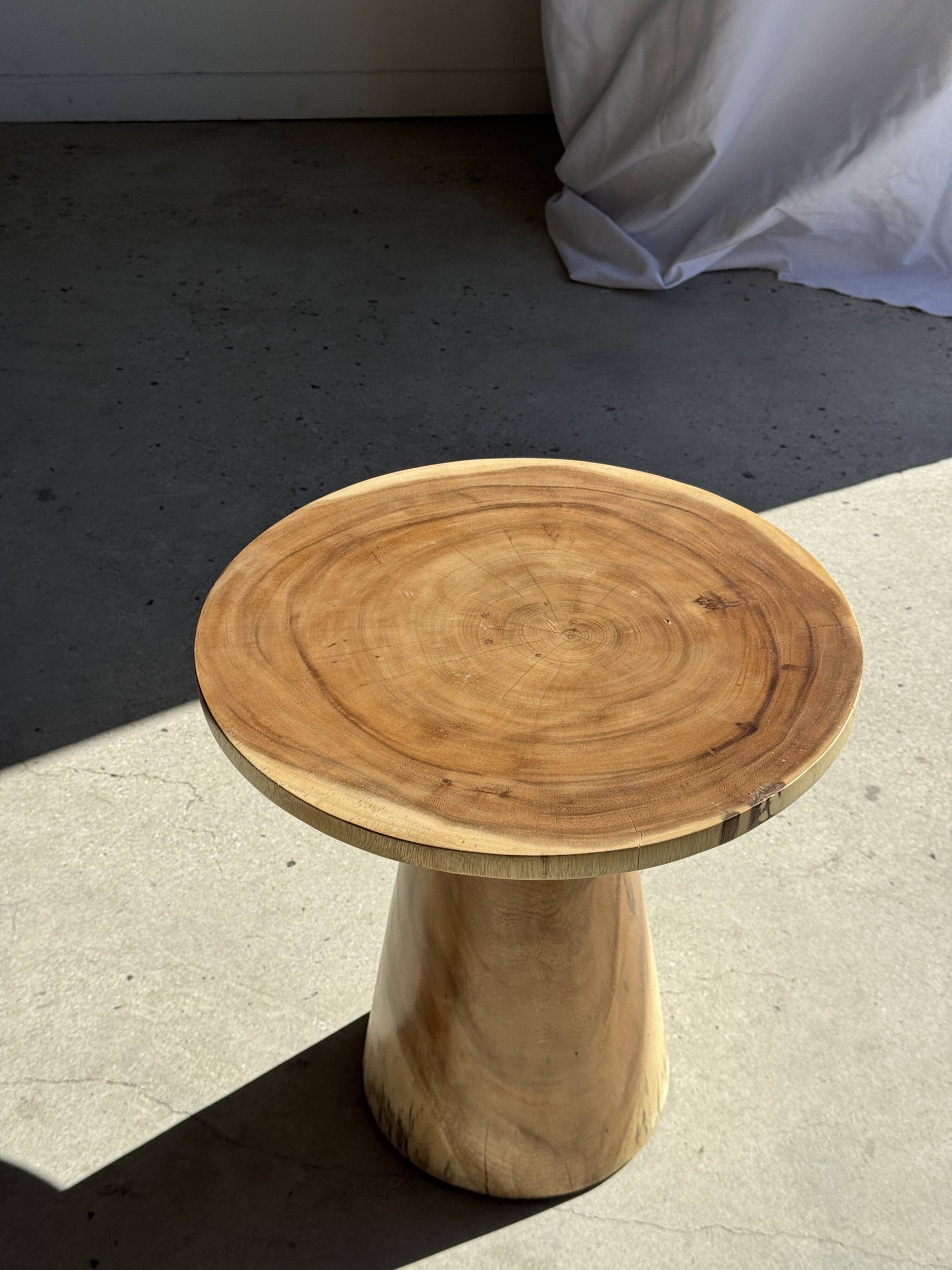 Natural solid suar side table (monoxyle) with a minimal conical base.