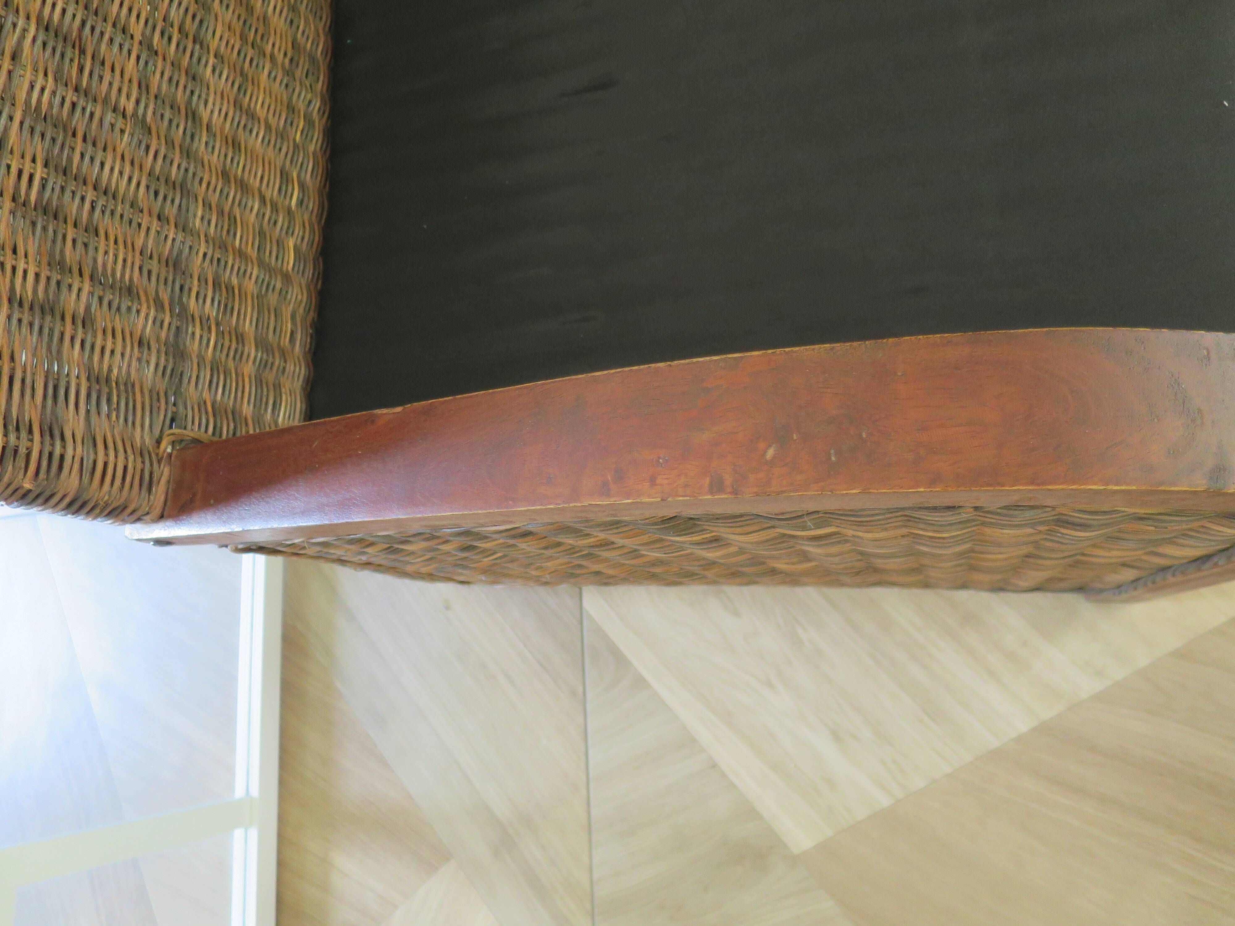 2 colonial-style armchairs in woven rattan and exotic wood