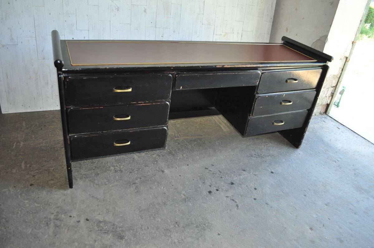 Hungarian Art Deco desk in black painted wood with a brown top and metal handles.