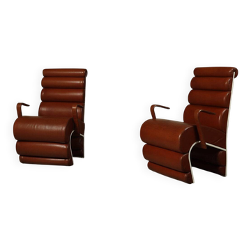 Pair of sculptural cognac leather armchairs, 1970s