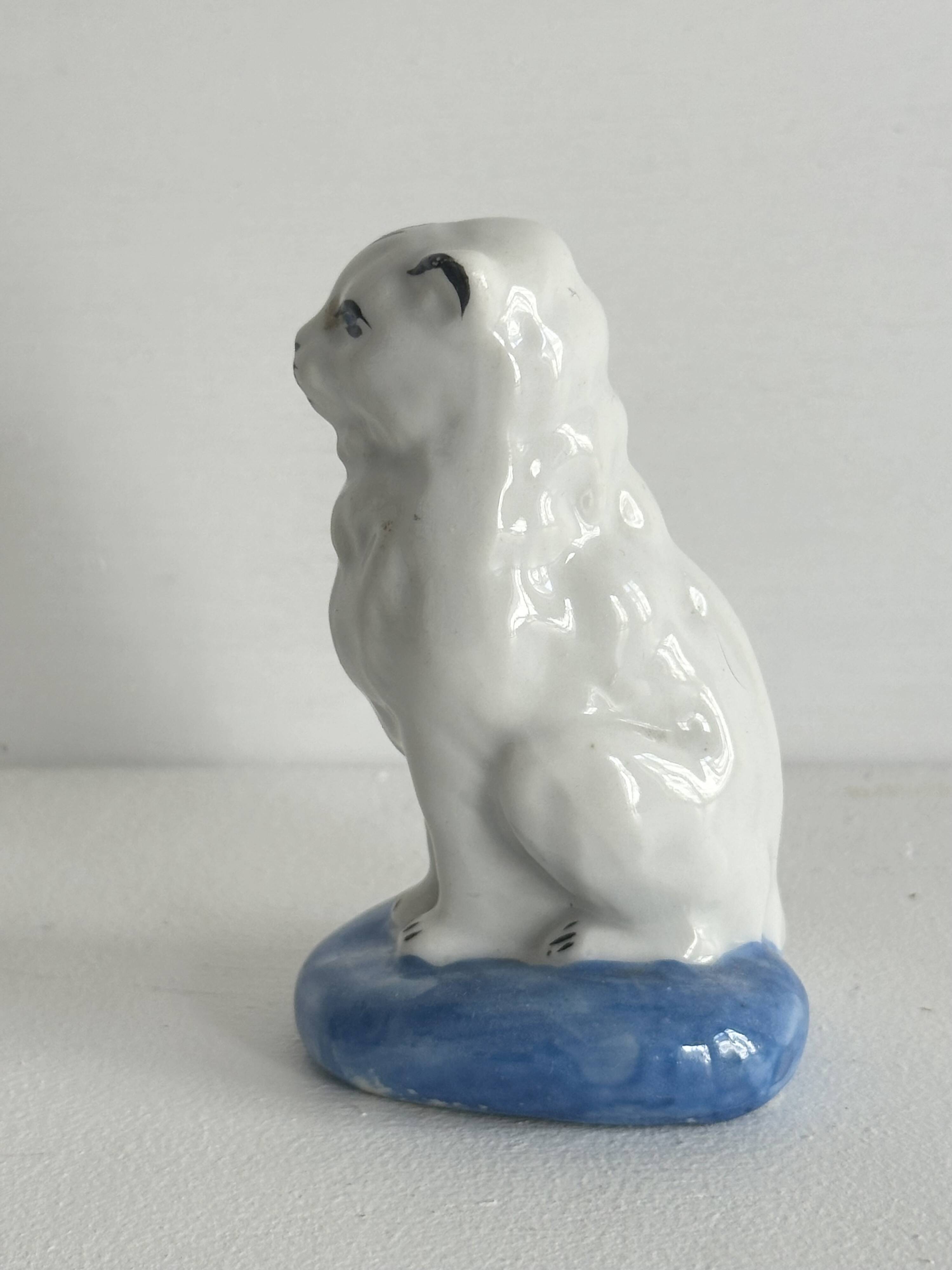 Small ancient glazed ceramic cat from the 19th century.