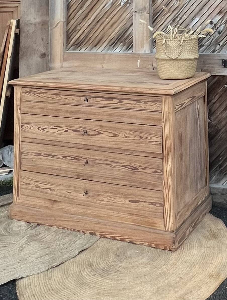 Large antique chest of drawers in raw solid wood.