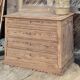 Large antique chest of drawers in raw solid wood.
