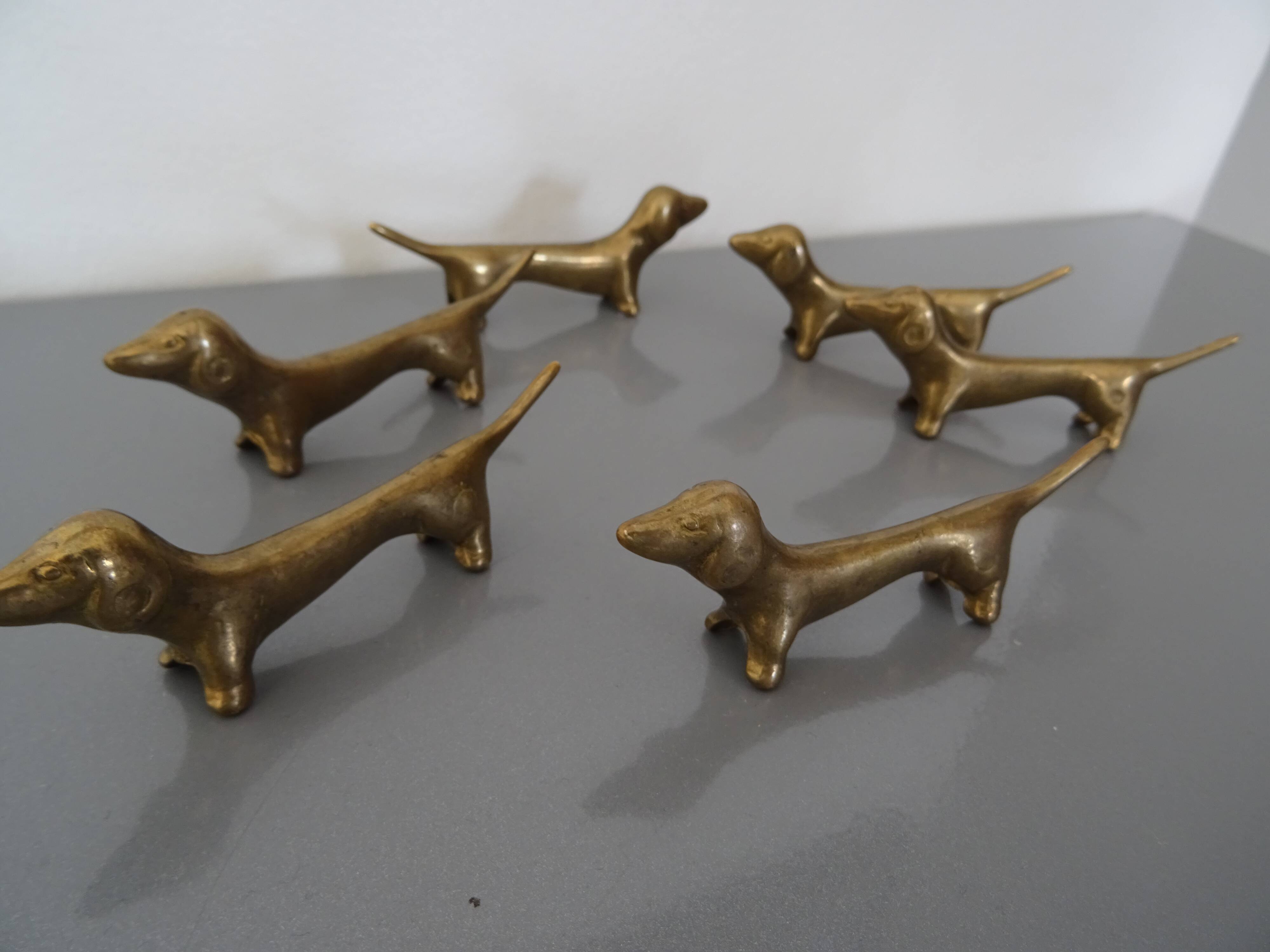 Series of 6 vintage gilded brass dachshund knife holders