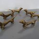 Series of 6 vintage gilded brass dachshund knife holders