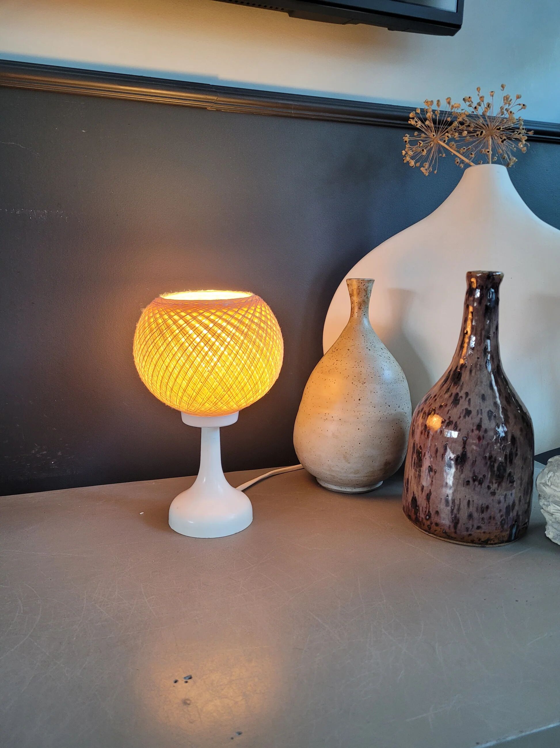 60's table lamp with tulip base and stretched wire shade.