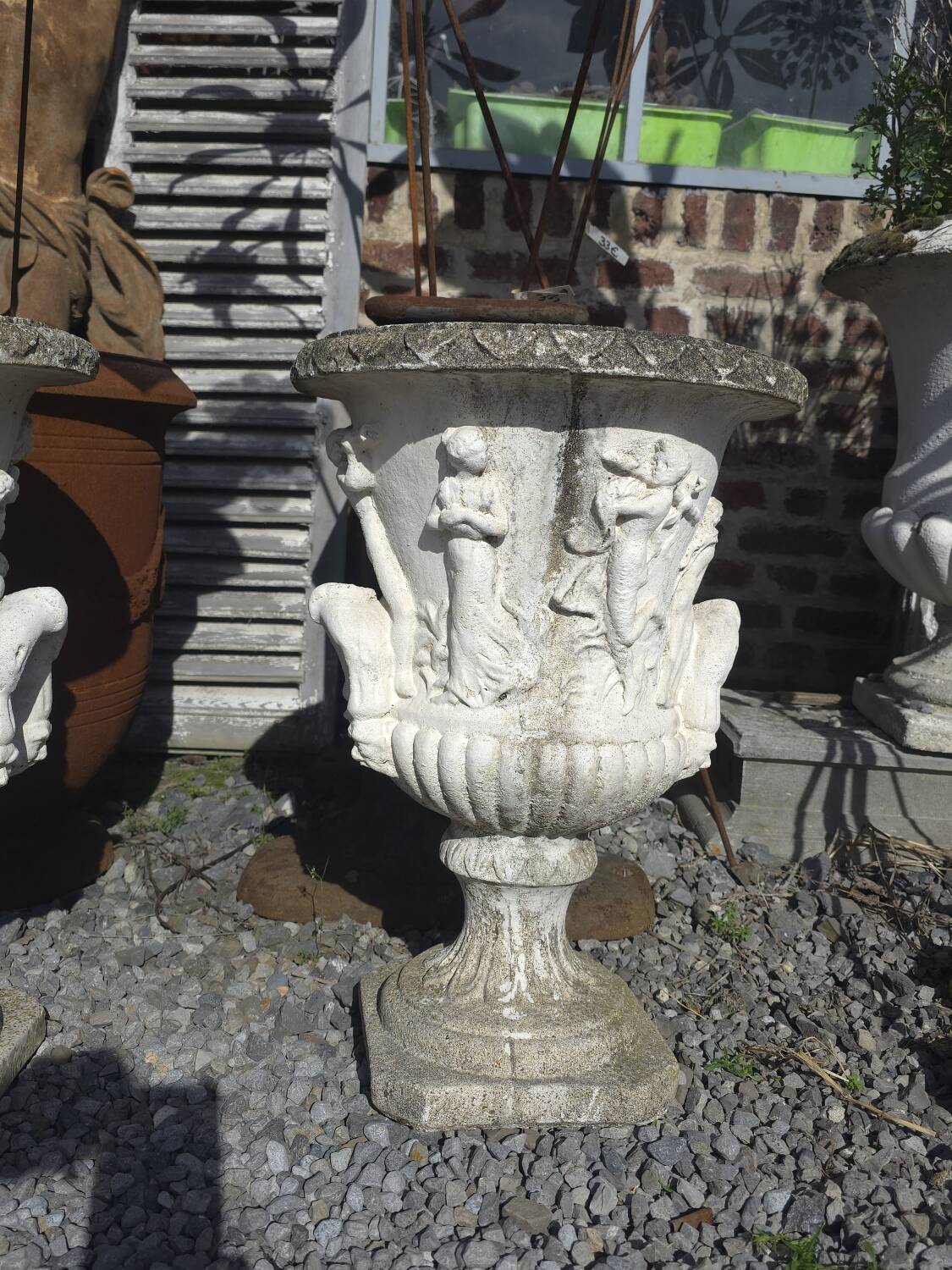 Medical vases with characters in reconstituted stone.