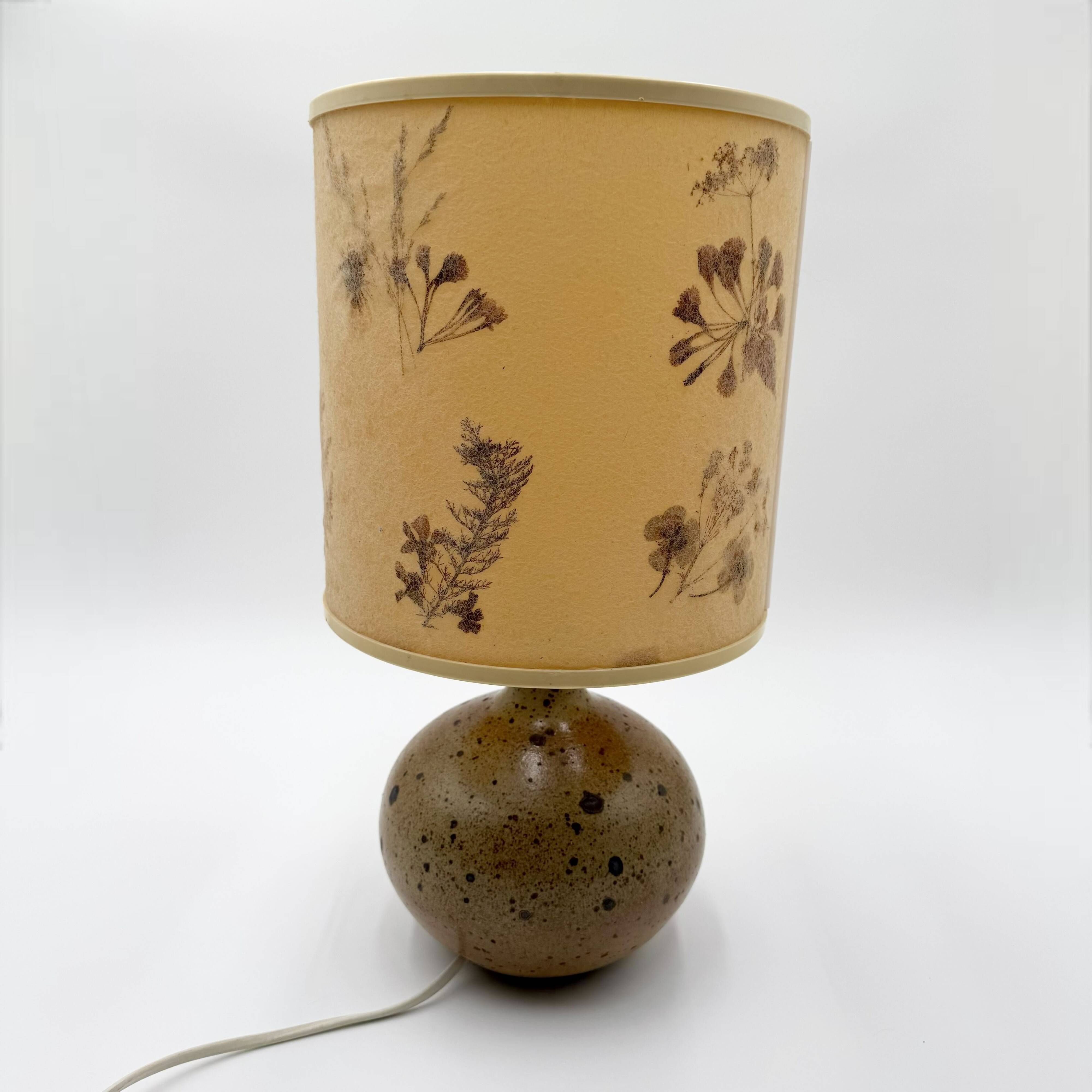 Pyrite stone ball lamp with a lampshade featuring dried flower inclusions.
