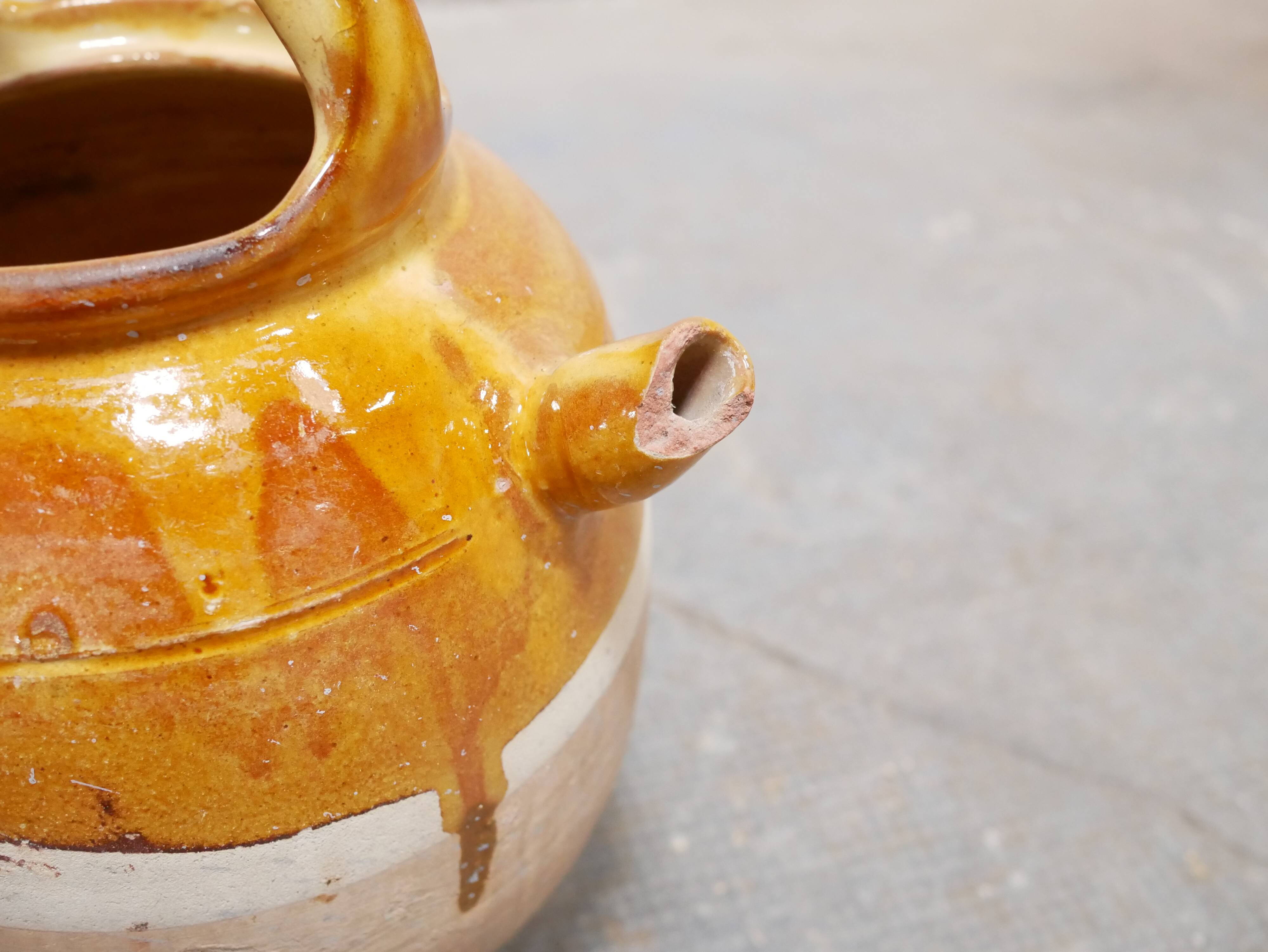 Old gargoulette pot in glazed terracotta