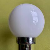 Pair of chrome metal wall lights with white glass globe.