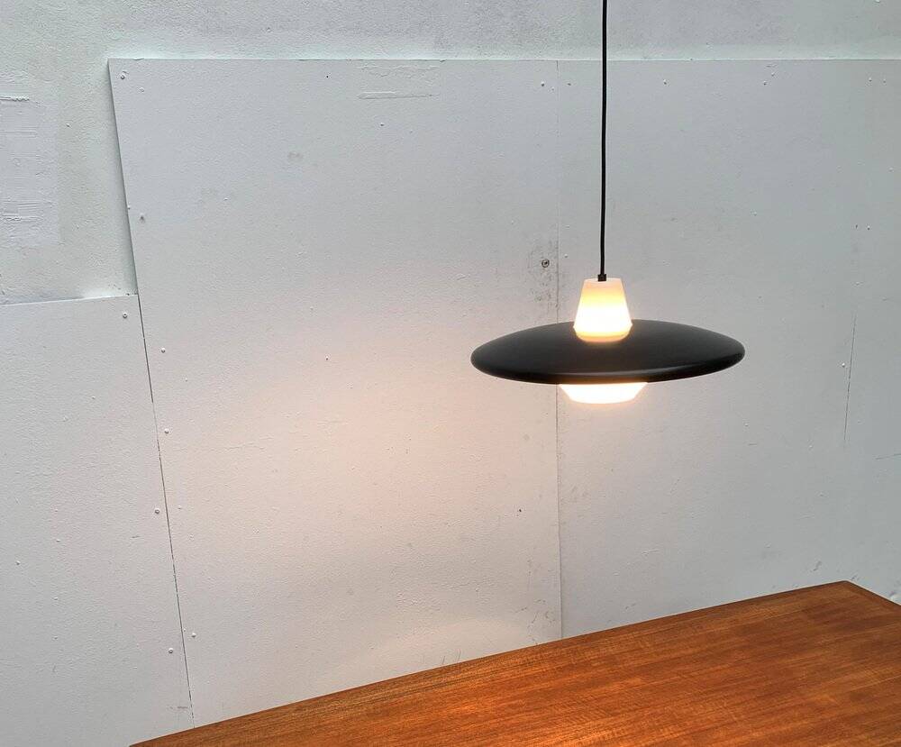 Minimalist metal and glass pendant lamp in mid-century style.