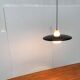 Minimalist metal and glass pendant lamp in mid-century style.