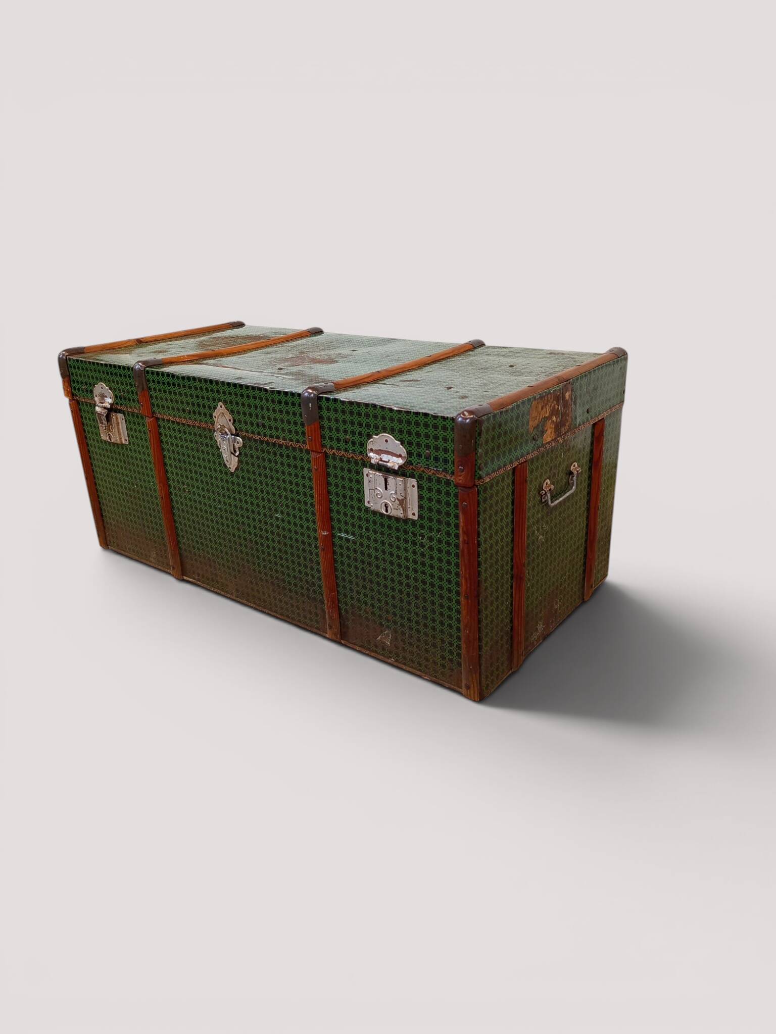 Vintage wooden and metal green travel trunk, circa 1930.