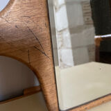 Old beveled hand mirror and wooden frame