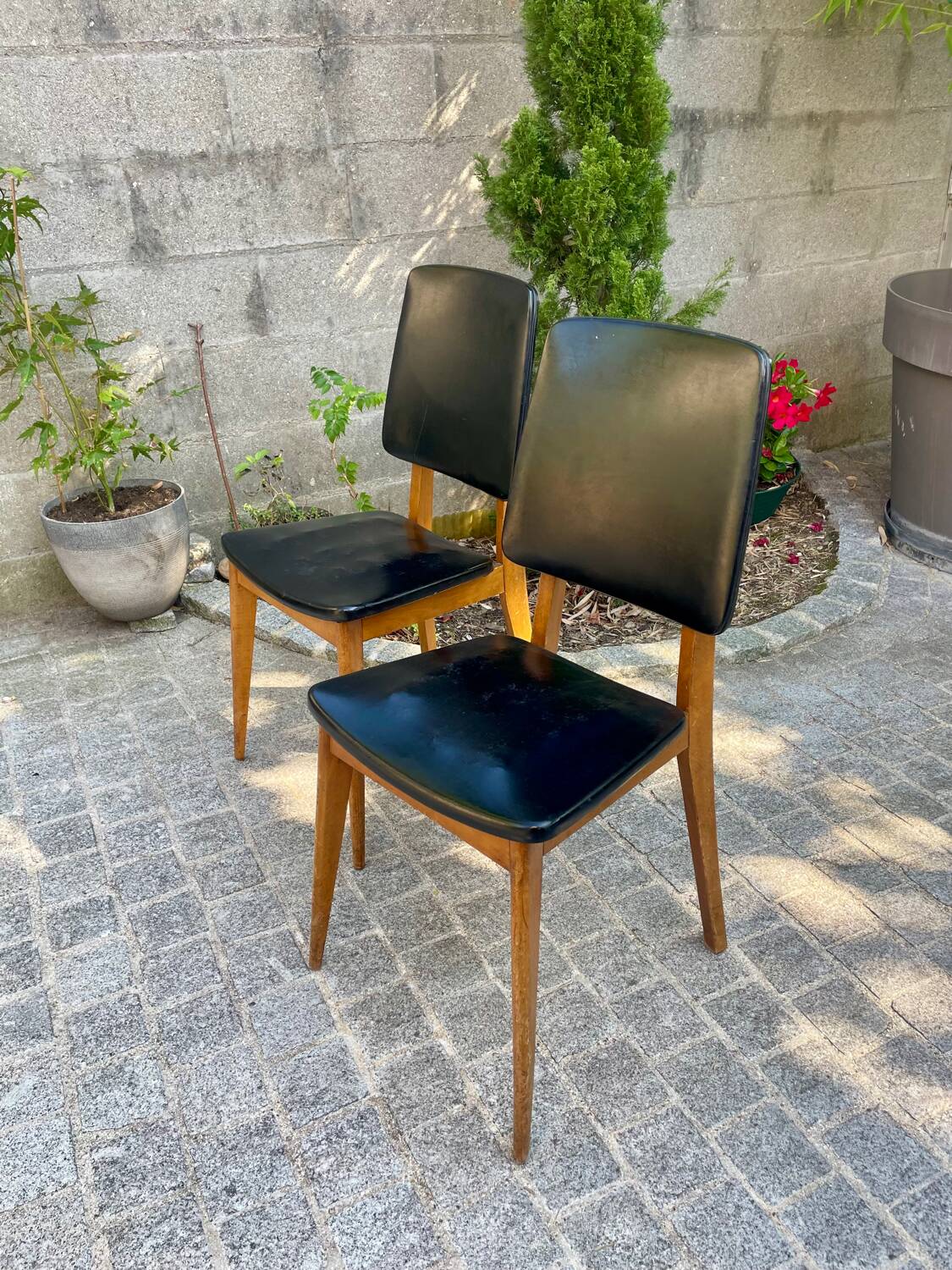Two vintage Scandinavian chairs in beech and black leatherette