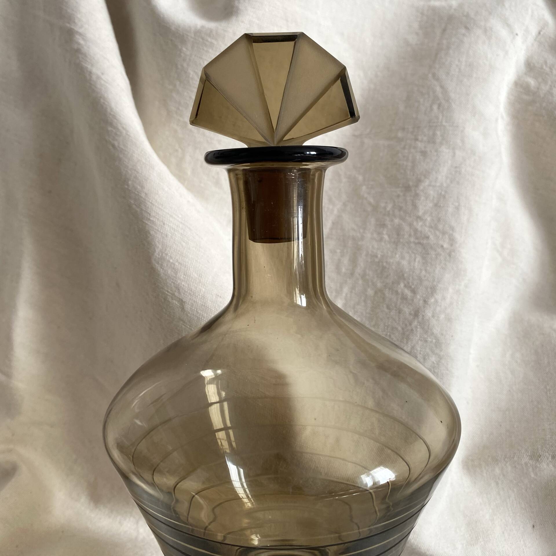 Art Deco smoked glass carafe with fan-shaped stopper.
