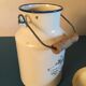 Enamelled milk jar retro style ecru color with "goose" patterns. Wooden handle.