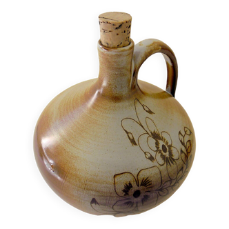 Glazed terracotta brandy bottle with plant decoration