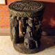 African wooden stool carved in the shapes of characters