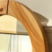 Round mirror in raw wood