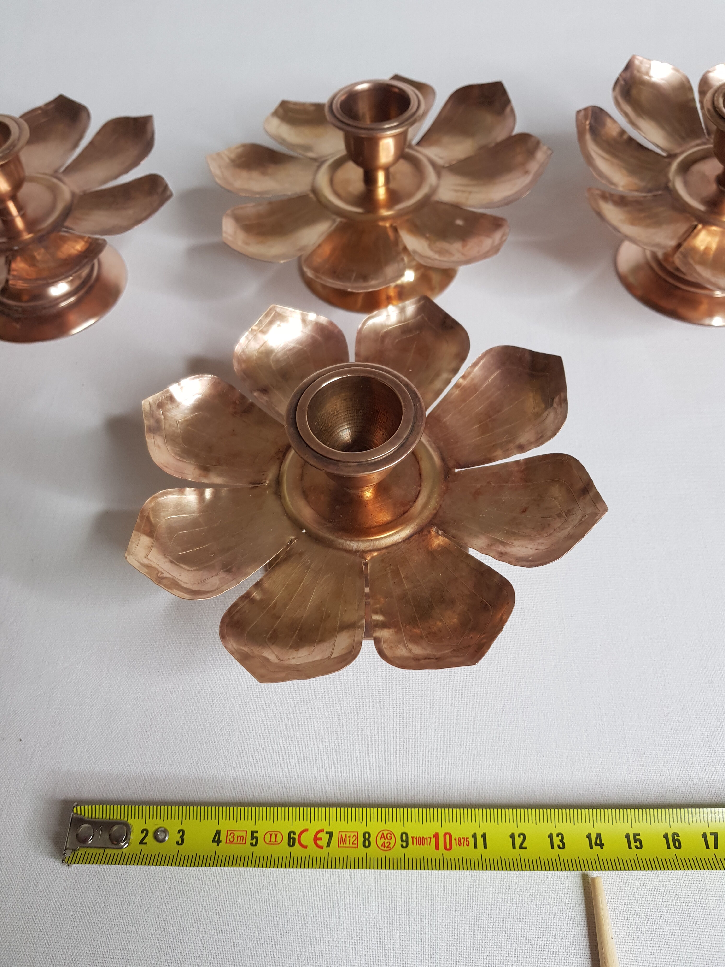 Set of four copper candlesticks in the shape of lotus flowers