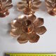 Set of four copper candlesticks in the shape of lotus flowers