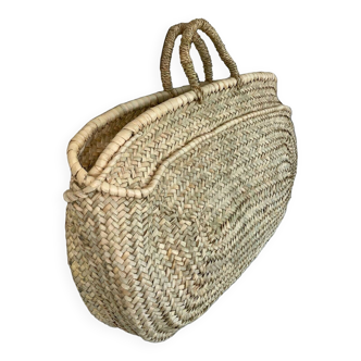 Woven basket in natural palm leaf
