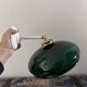Tilting wall light in green opaline