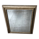 Beveled mirror under gold frame