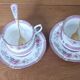 Duo of English porcelain tea cups from Queen's Richmond and spoons.