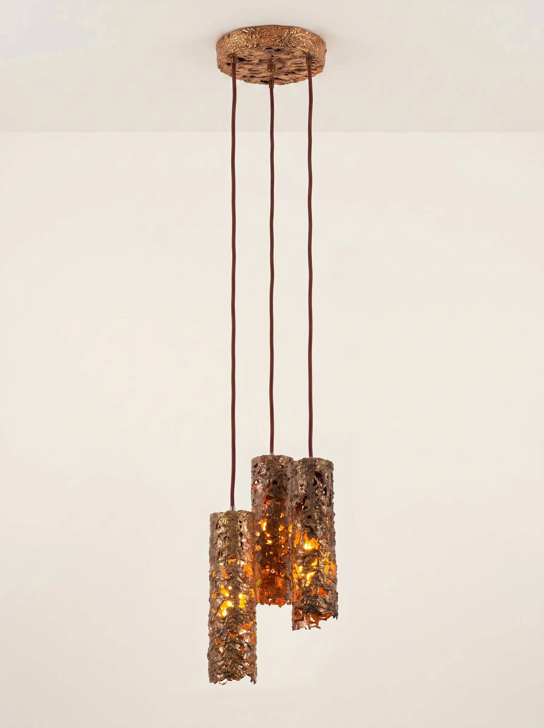 Suspension composed of 3 brutalist copper lamps by Aimo Tukiainen, 1960s.
