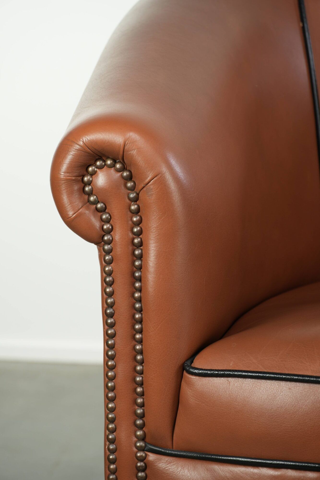 Cowhide club armchair in English style with comfortable seating.