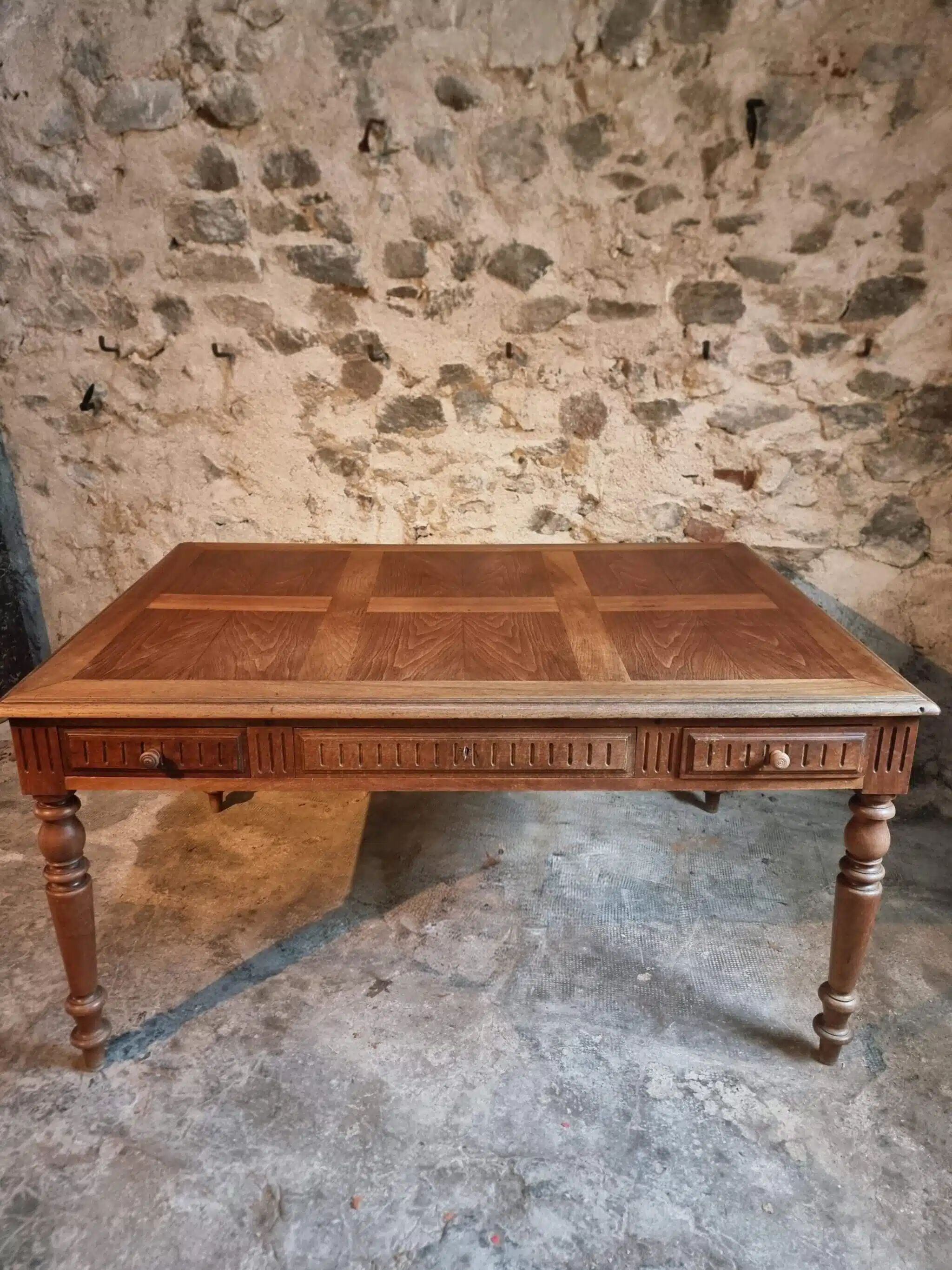 Antique French walnut table with six drawers, parquet top, early 20th century.