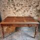 Antique French walnut table with six drawers, parquet top, early 20th century.