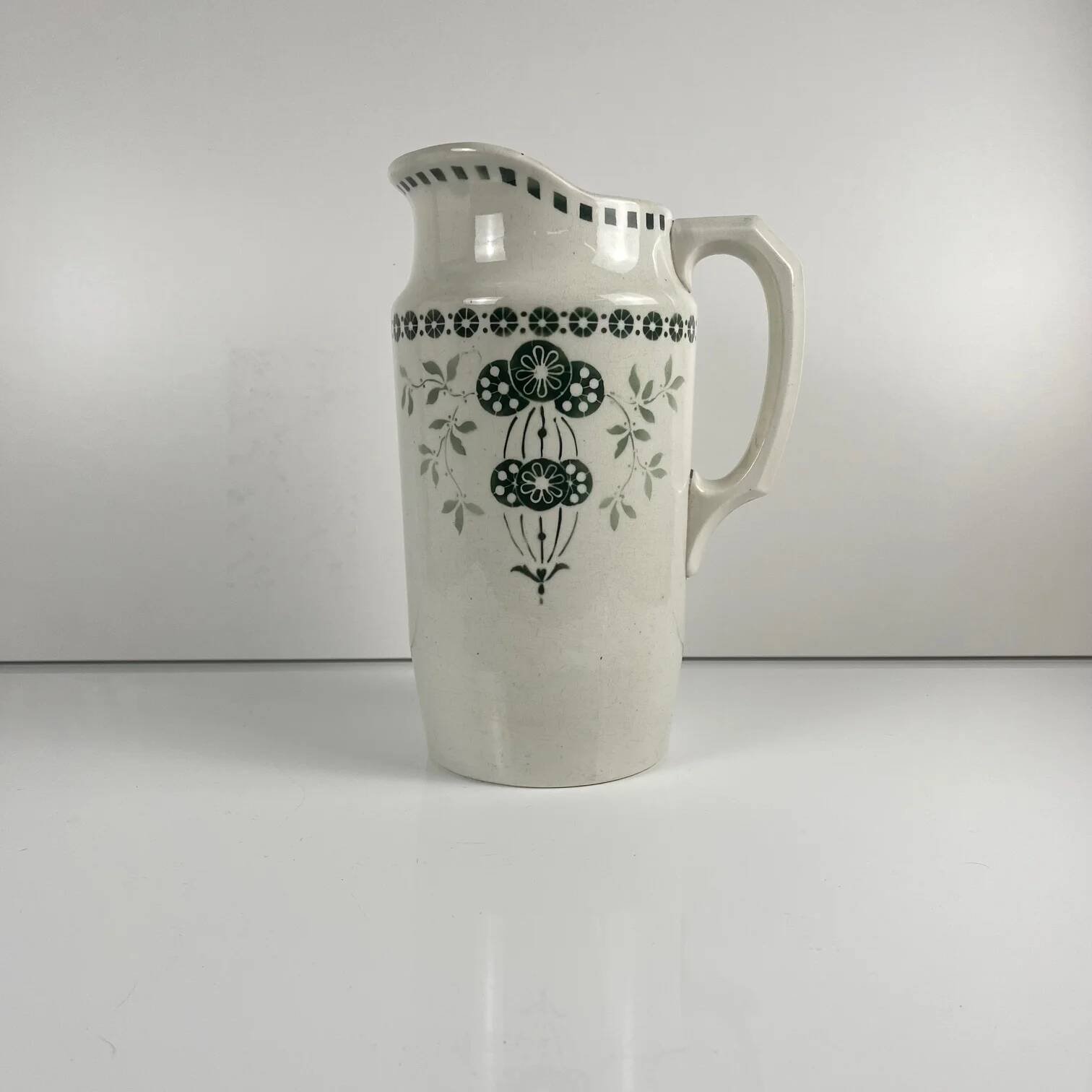 Antique earthenware pitcher, green floral decoration, fine ironstone from the late 19th to early 20th century.