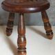 Low tripod stool in vintage turned solid wood