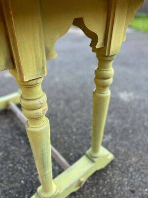 Old table with patinated green legs