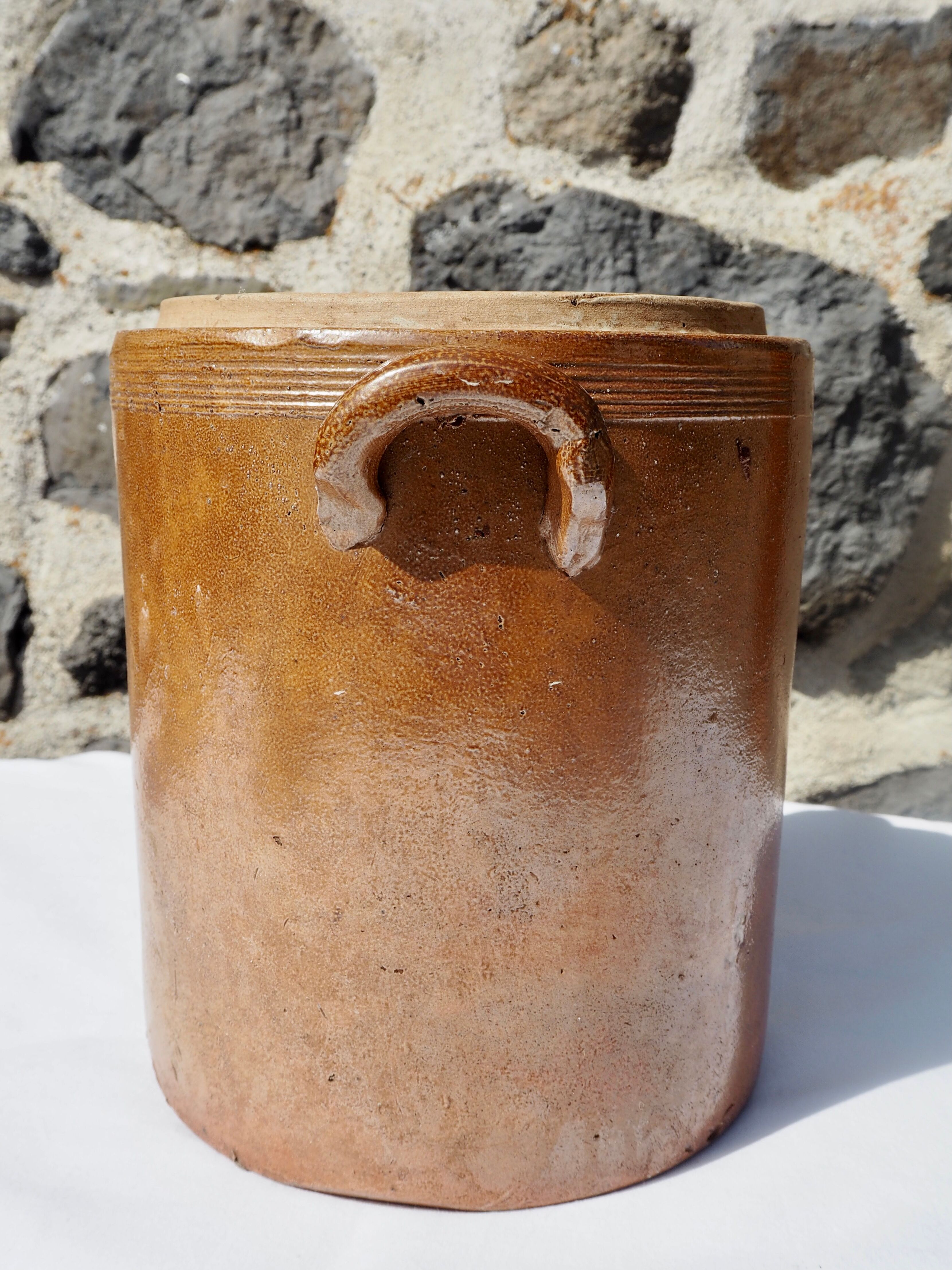 Trio of stoneware pots with lids