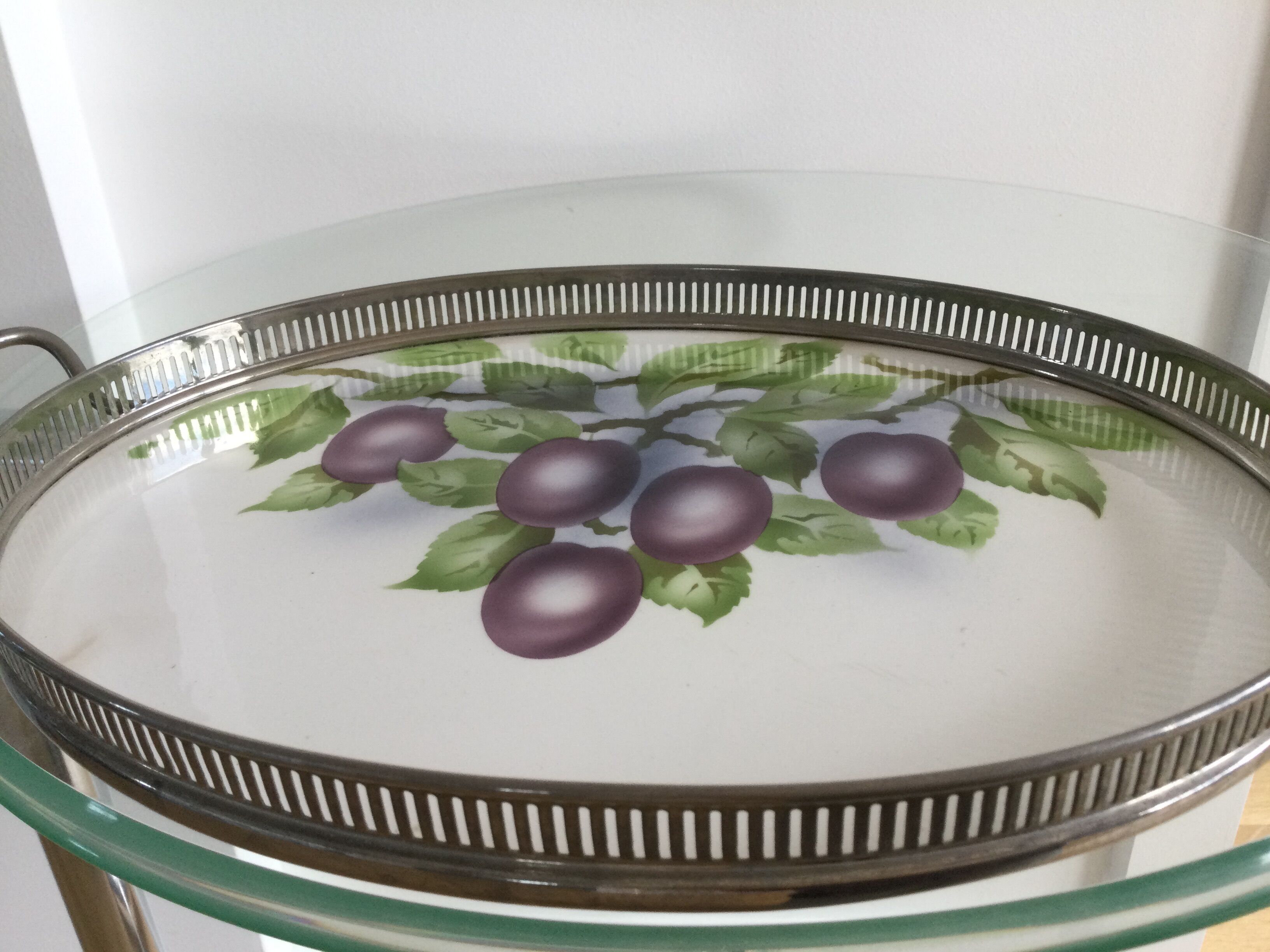 Vintage earthenware tray surrounded by antique metal