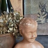 Bust of a small child in ancient plaster